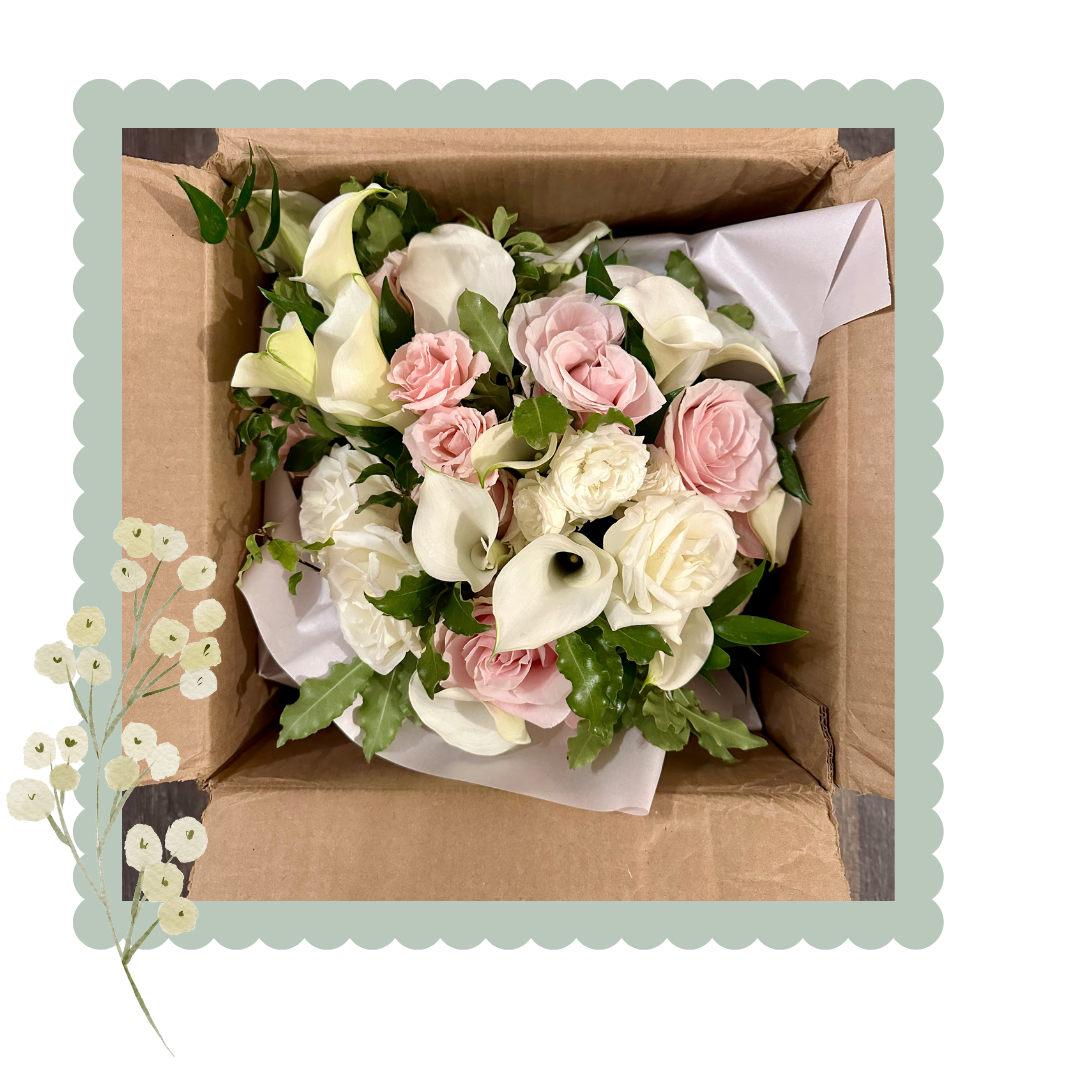 Bouquet of flowers in a cardboard box with decorative elements.