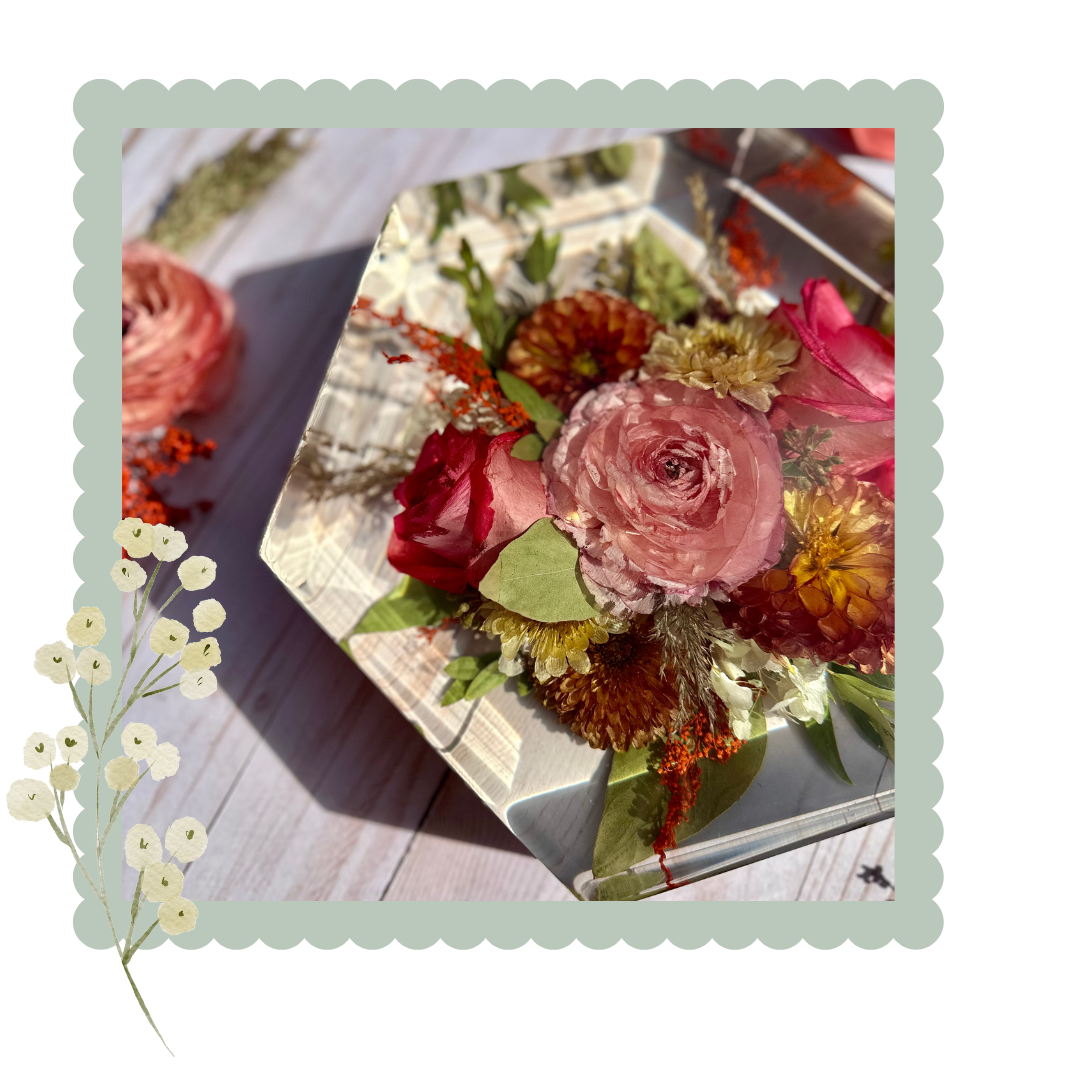 Decorative resin floral arrangement on a textured surface with a decorative border.