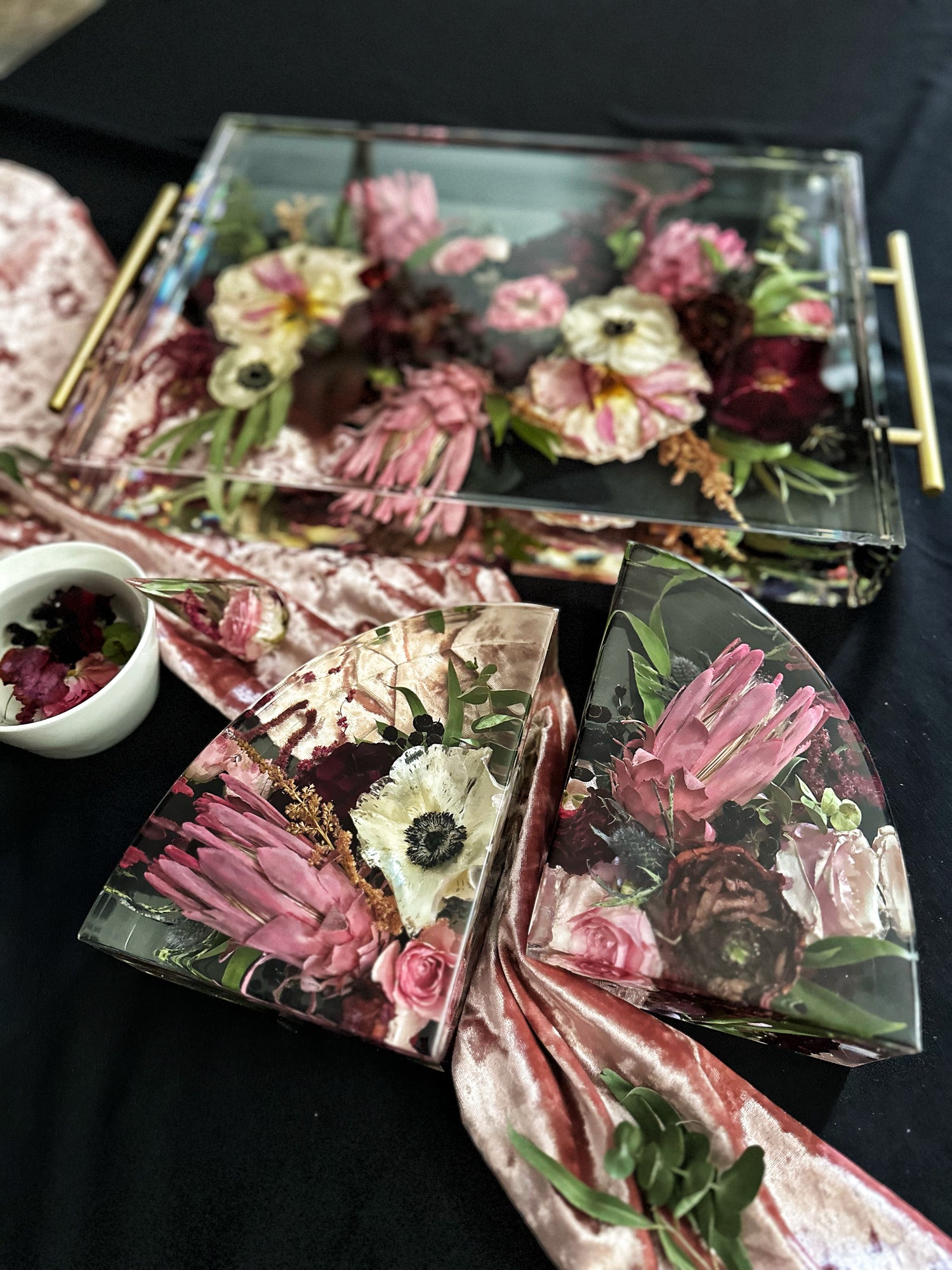 Decorative resin tray with floral design on a dark surface
