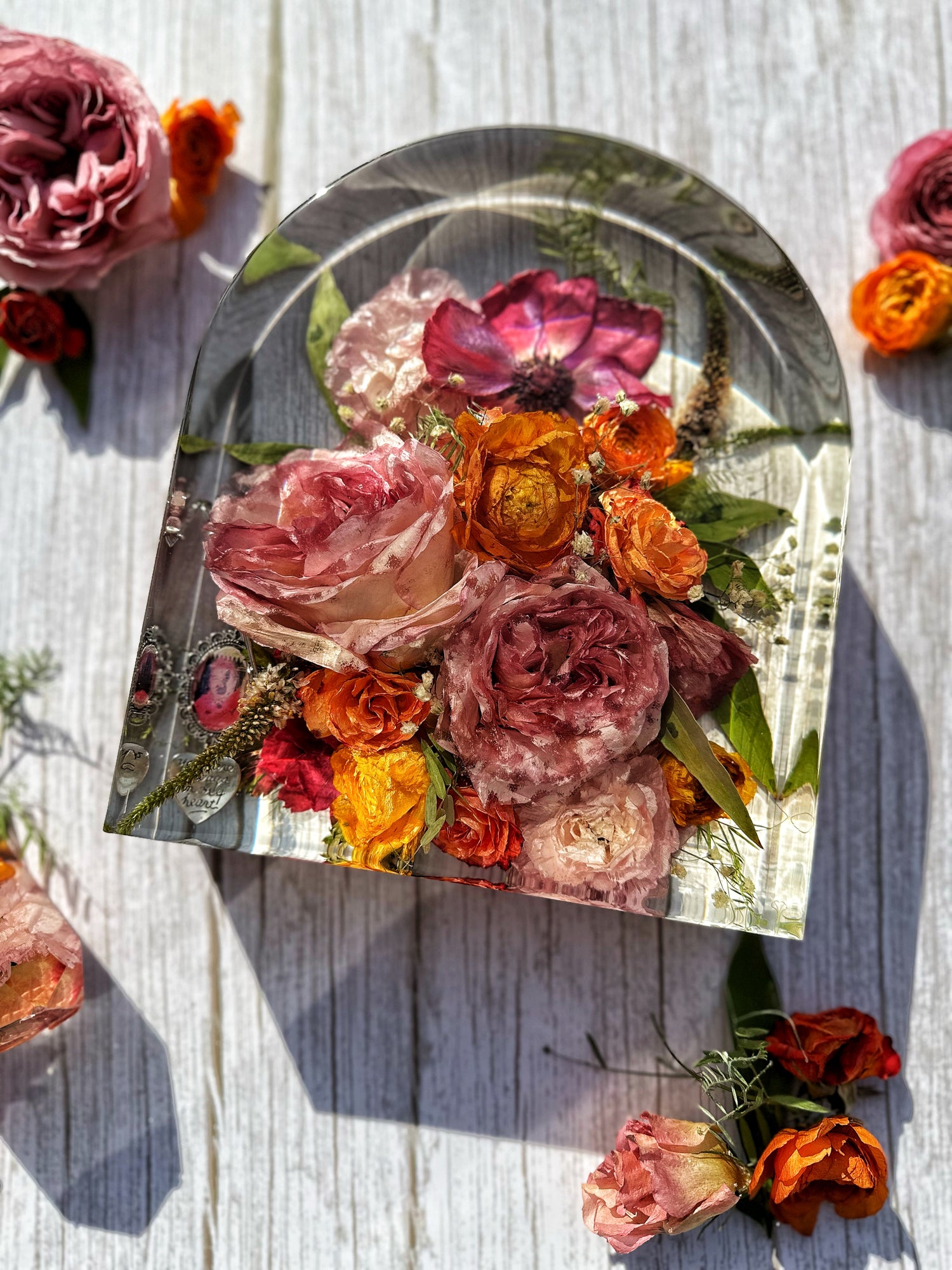 Decorative resin arch with floral design on a wooden surface